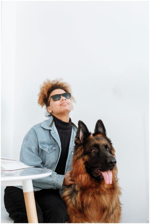 A woman with sunglasses sits beside her German She