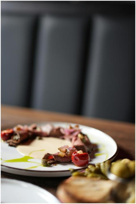 Elegant gourmet beef dish garnished with cherry to