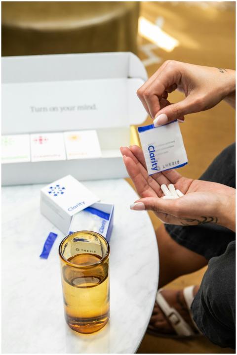 Close-up of hands holding supplement sachets with