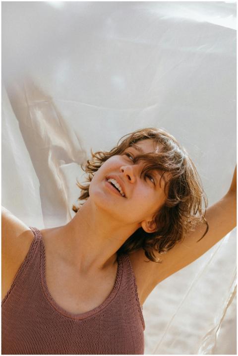 Smiling adult woman with short hair enjoying sunny