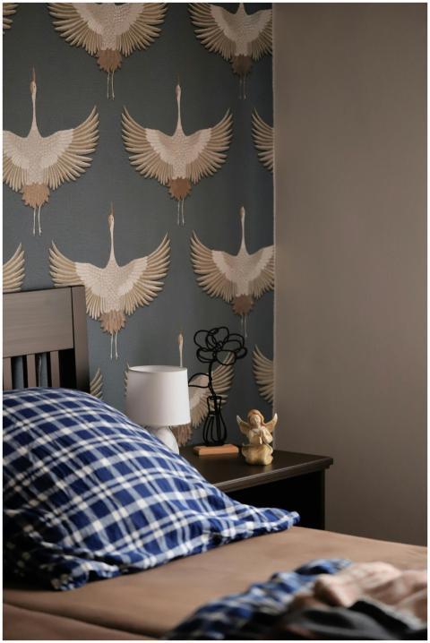 Elegant bedroom featuring crane-themed wallpaper a