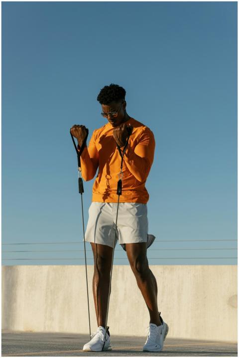 A man performs exercises with resistance bands on