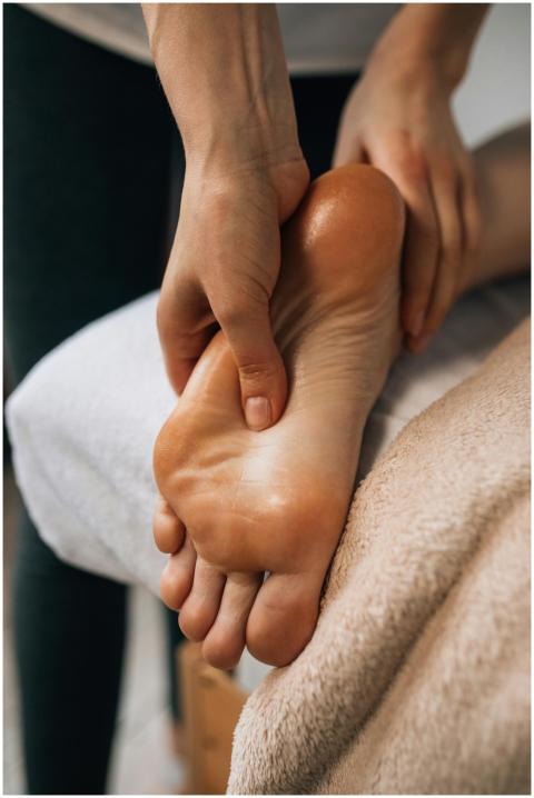 Hands massaging a foot to provide relaxation and p
