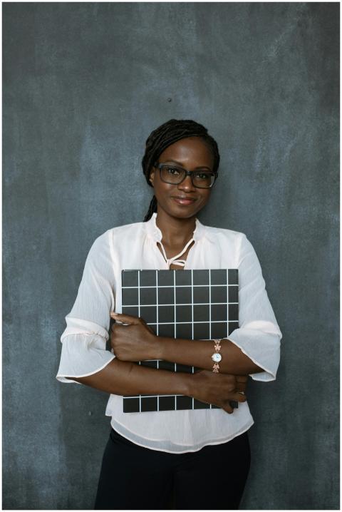 Professional woman standing with a grid board agai