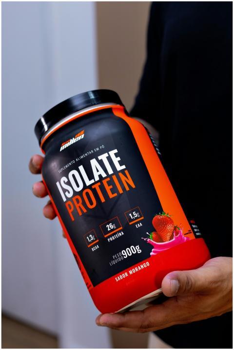 Close-up of a hand holding an Isolate Protein cont