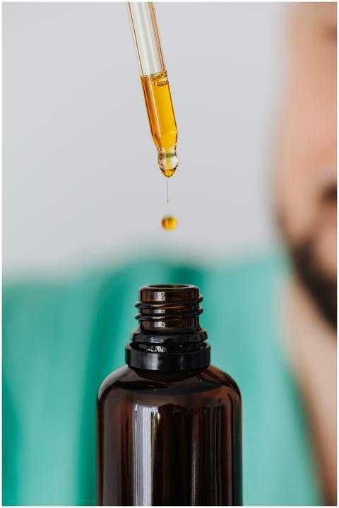 Detailed view of a pipette dropping essential oil