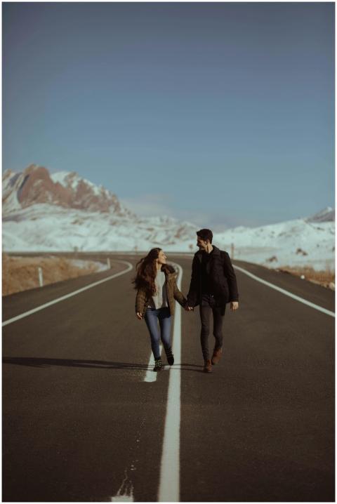 A romantic couple walking hand in hand on a scenic