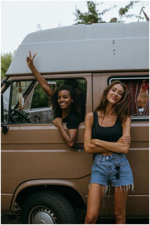 Two women enjoying a fun road trip, posing beside