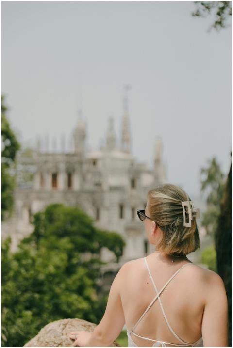 Rear view of a woman in summer attire looking at Q