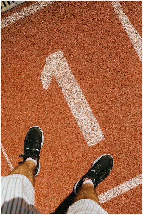 Man standing on number one lane of outdoor running
