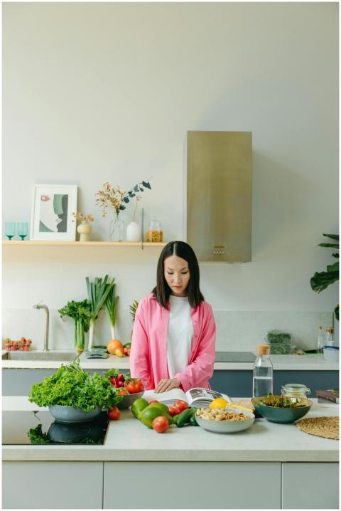 Asian woman reading recipe and preparing a healthy