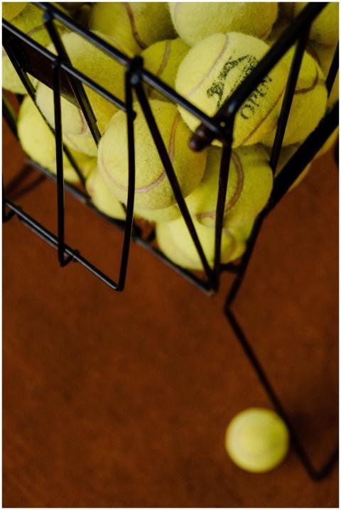 Detailed view of tennis balls stored in a metal ba