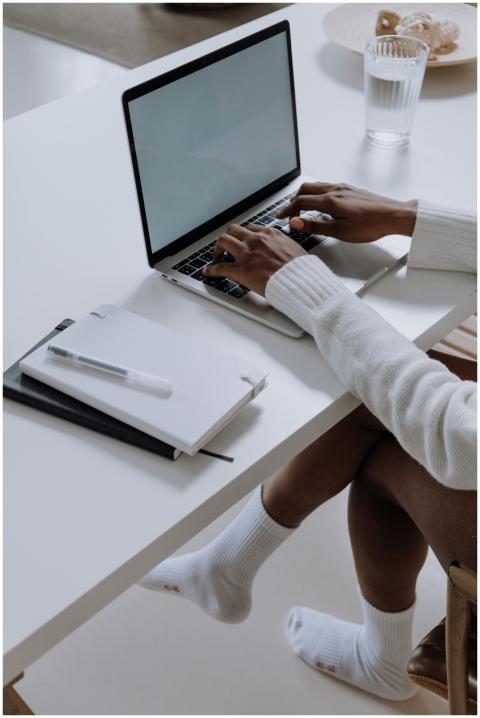 A woman working on a laptop in a modern home offic