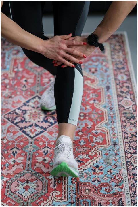 Close-up of a woman's leg stretching on an ornate