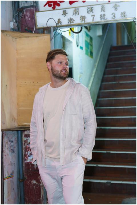 Stylish man in casual attire in a vibrant Asian st