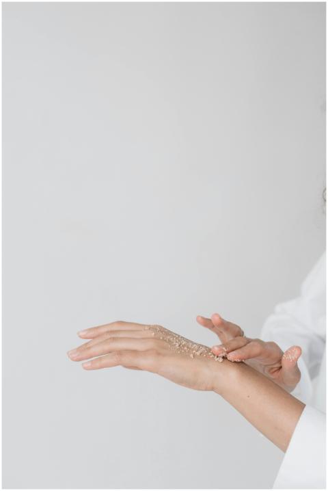 Close-up of a hand applying scrub for a skincare r