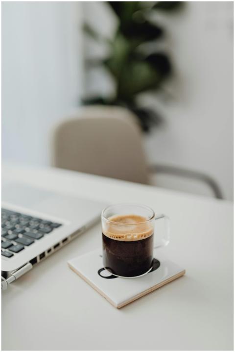 A clean and modern workspace featuring a coffee cu