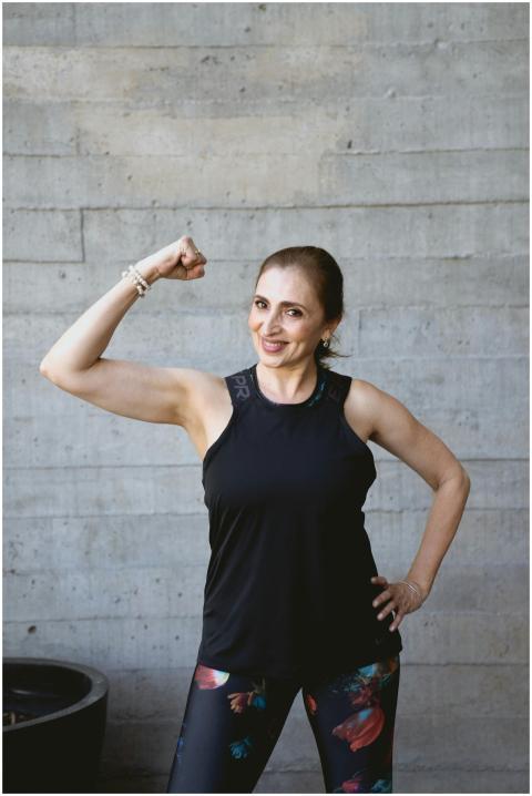 Confident senior woman flexing her arm, showcasing