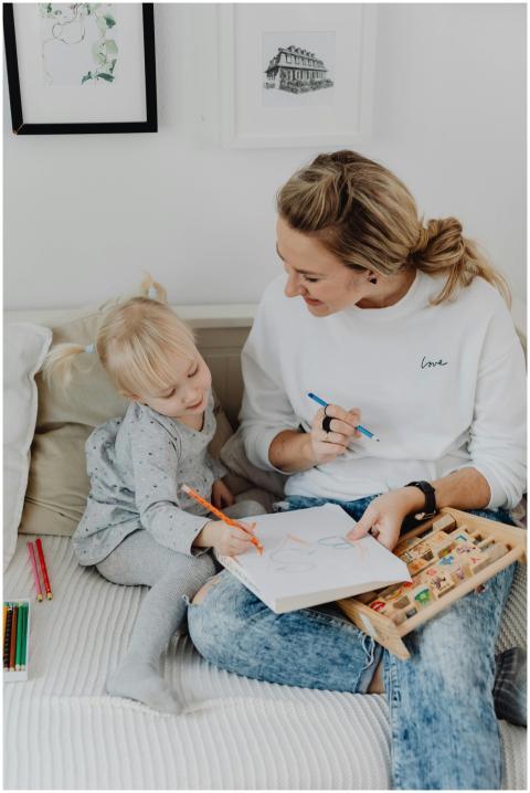 A mother and her daughter drawing together, enhanc