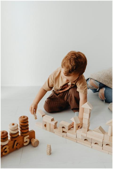 Young boy constructing with wooden building blocks