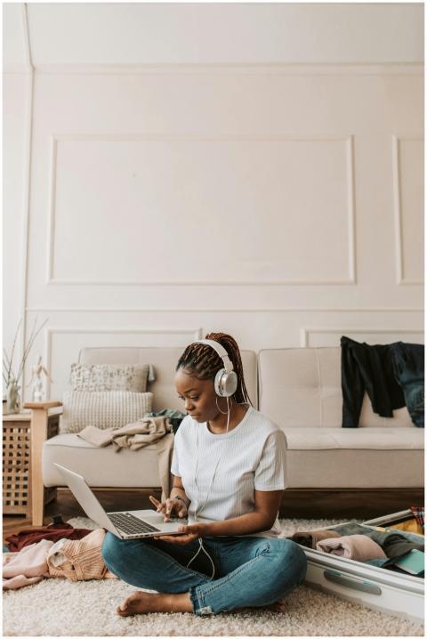 Young woman with braided hair sitting cross-legged