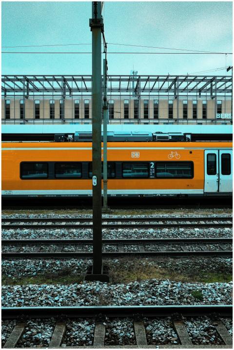 A vibrant orange train at Munich station, showcasi