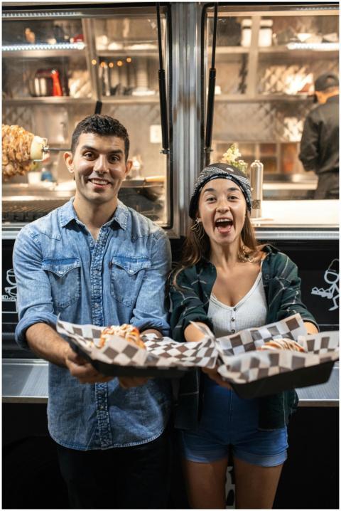 Cheerful couple with diverse backgrounds holding f