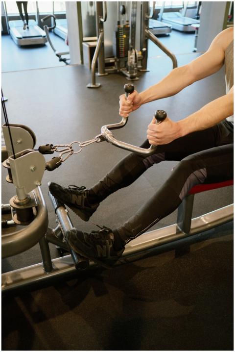 Adult male working out on a rowing machine in a mo