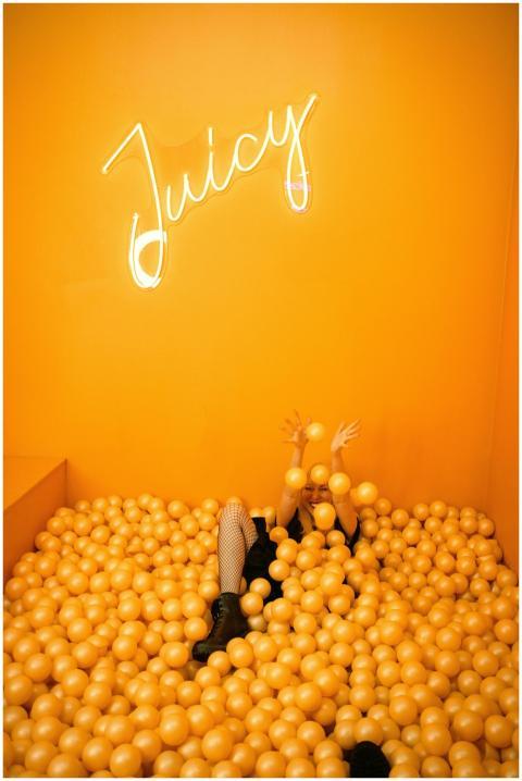 Playful scene with a teenager enjoying an orange b