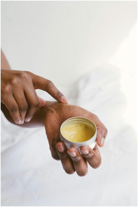 Close-up of a hand applying natural skincare cream