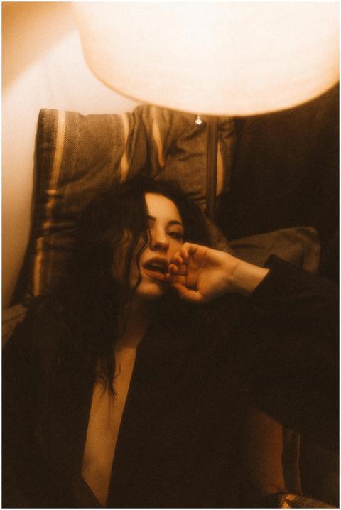 Vintage-inspired portrait of a woman in warm lamp-