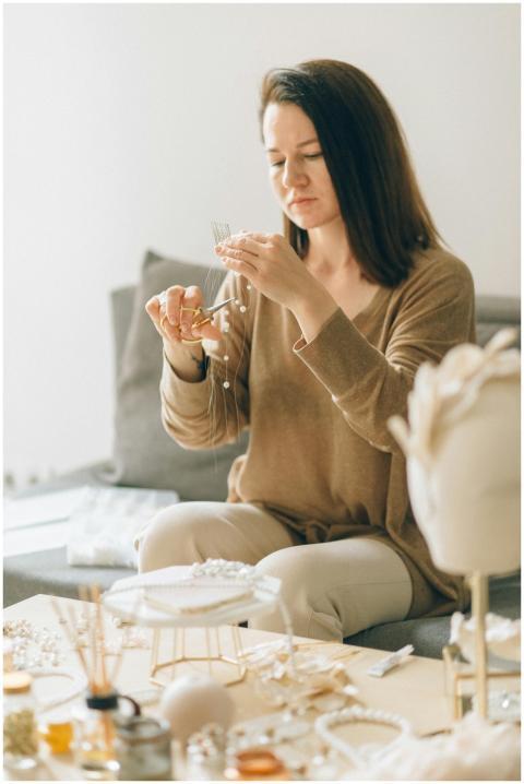 Adult woman focused on crafting handmade jewelry w