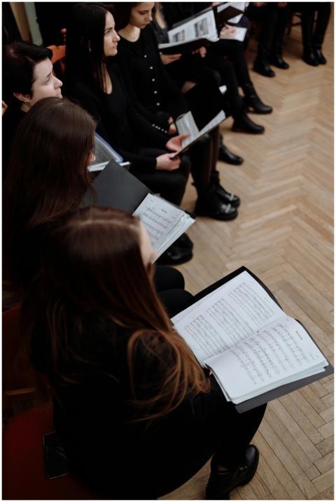 A group of women in black clothing rehearsing with