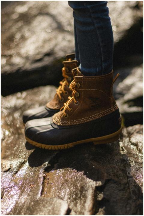 Close-up of durable boots on rocky terrain, perfec