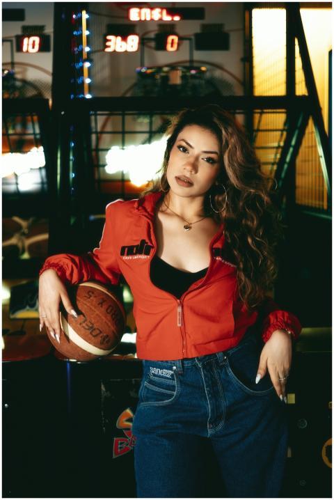 Confident woman in casual outfit posing with baske