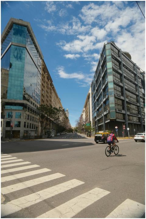 Cyclist on a sunny day amidst modern buildings in