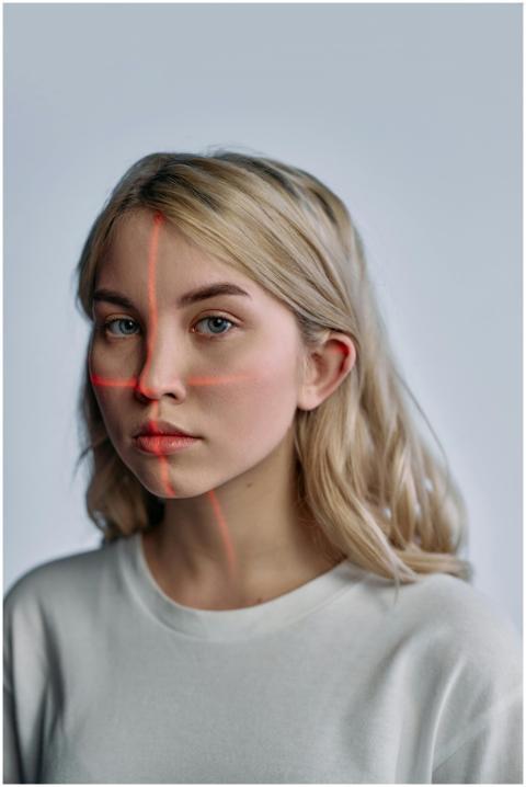 A woman with laser lines on her face highlighting