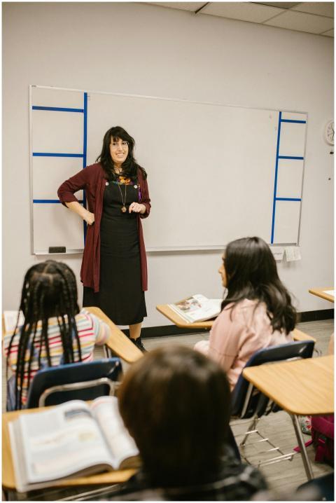 A teacher engages students in a classroom discussi