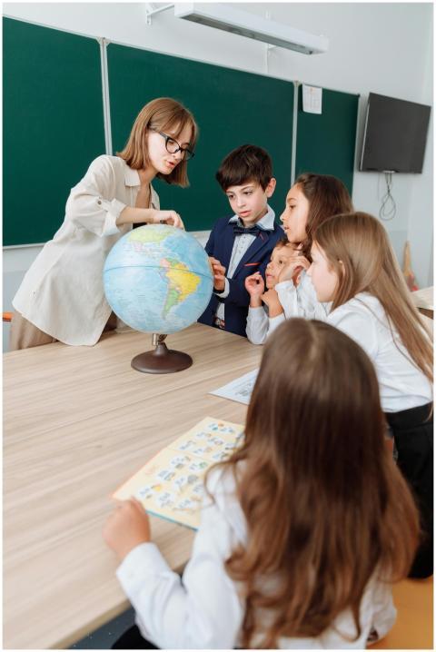 Teacher and students exploring geography with a gl