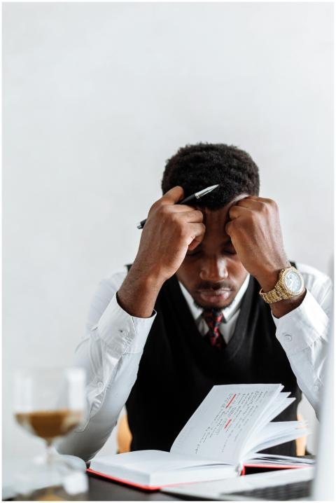 A frustrated businessman sits at a desk reviewing