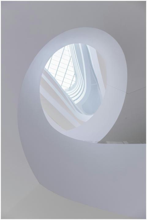 A stunning low-angle view of a modern spiral stair
