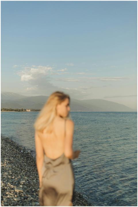 A serene image of a blonde woman in a dress walkin