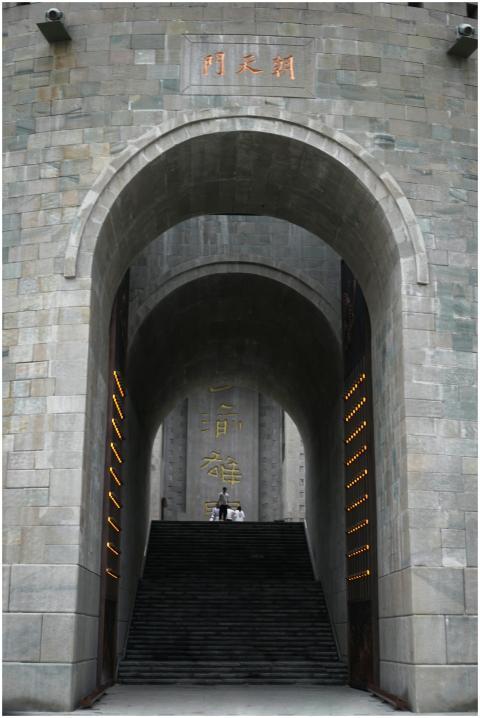 A striking stone archway leading to a grand stairc