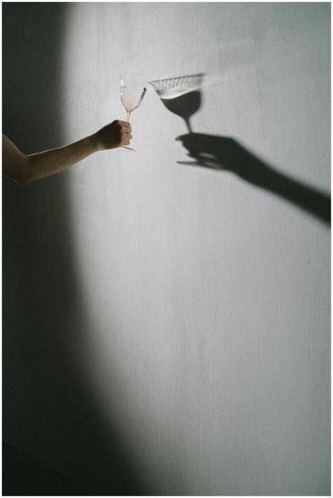 Artistic minimalist photo of a hand holding a wine