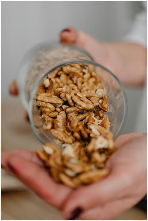 Close-up of walnuts being poured from a glass onto