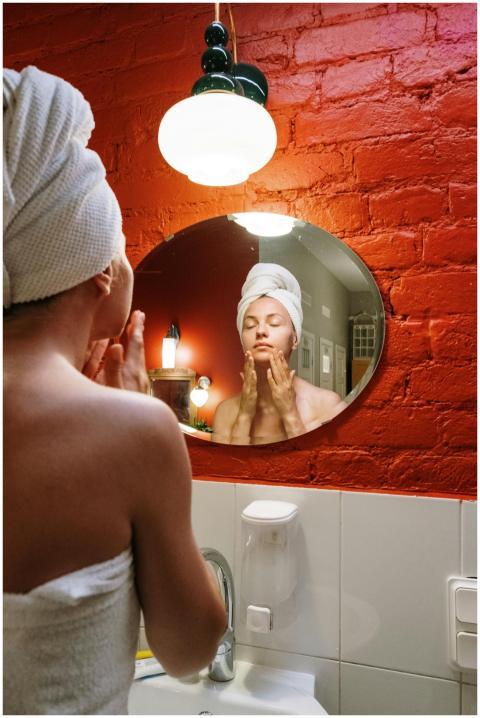 Woman performing daily skincare routine in modern