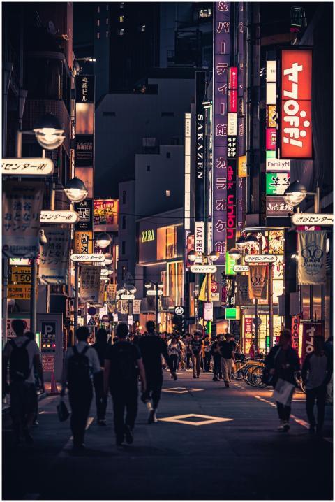 Bustling street in Tokyo at night filled with neon
