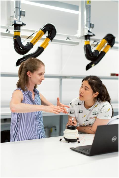 Two women engineers discussing a project in a high