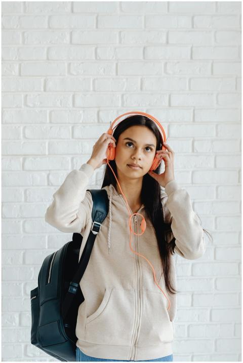 Teenage girl wearing headphones and backpack again