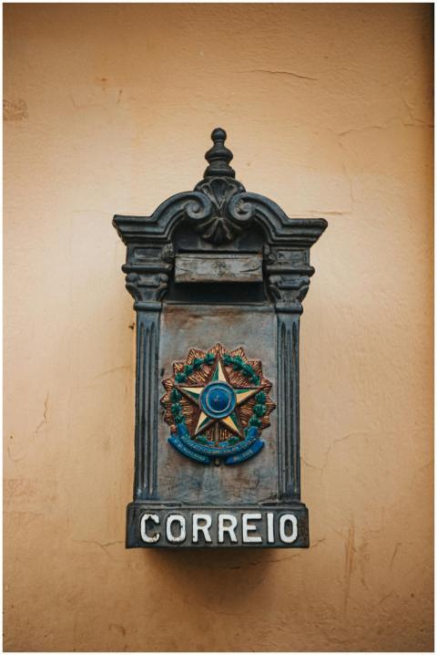 An ornate vintage Brazilian mailbox against a rust